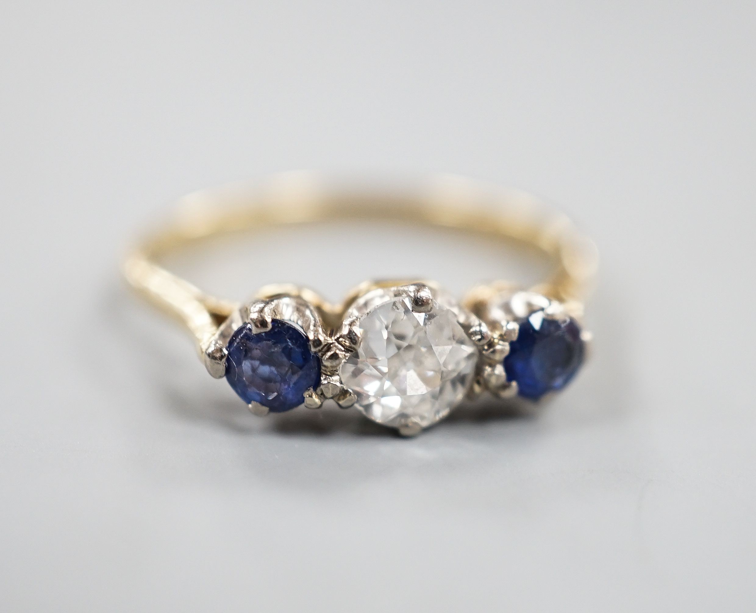 An 18ct & Plat, two stone sapphire and single stone diamond ring, size R, gross weight 3.1 grams.